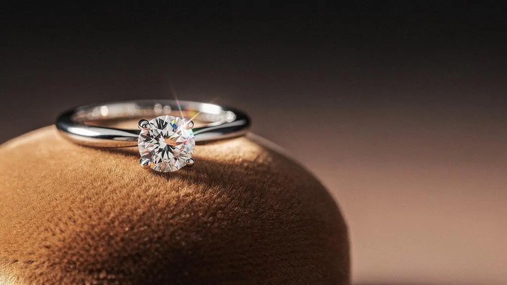 Bague solitaire en diamant mise en valeur sur un fond neutre illustrant le choix des 4C pour optimiser un budget